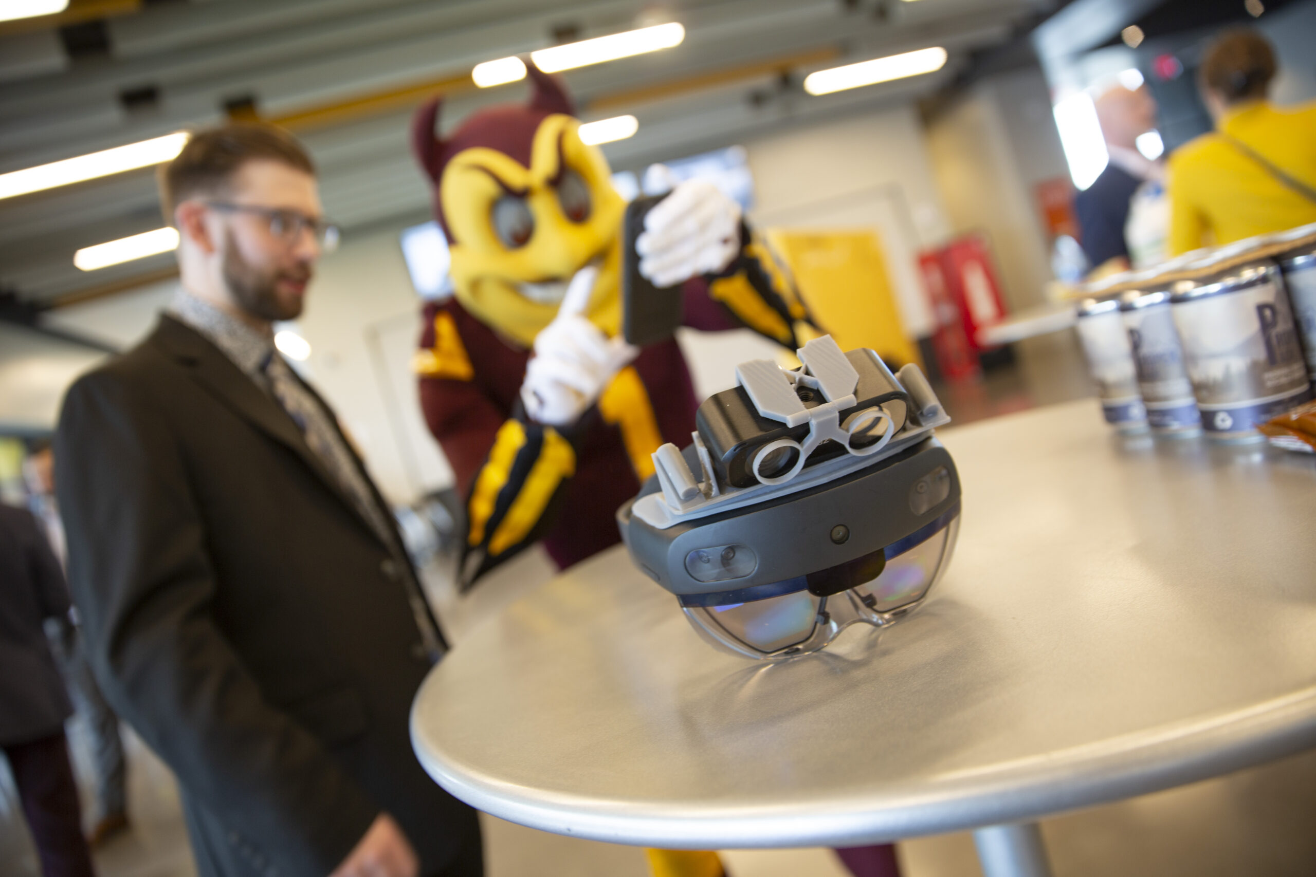 An ASU.io participant demonstrates his invention to Sparky, the mascot for Arizona State University.