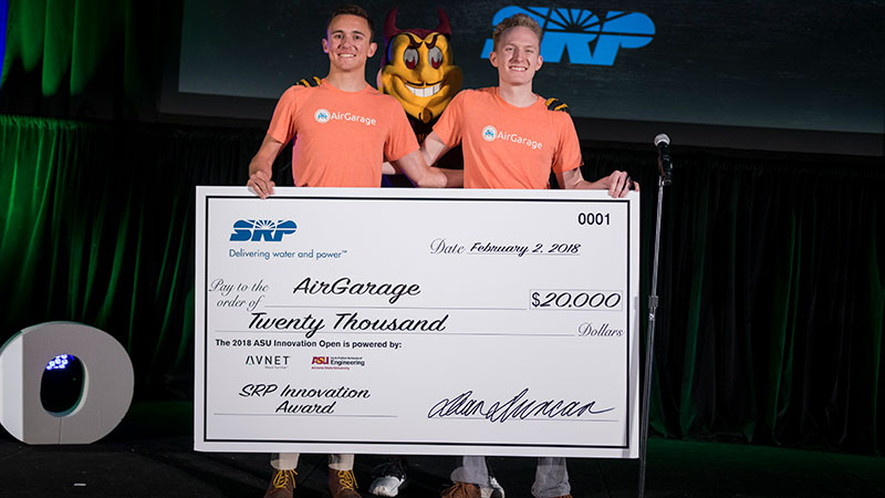 ASU entrepreneurs standing in front of their large award check.